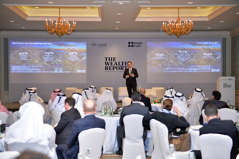 Event photo showing speakers on stage.