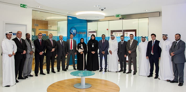 Photo showing a branch opening ceremony with attendees.